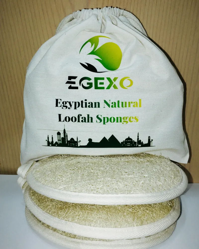 An EGEXO printed cotton bag above a stack of oval loofah pads with cotton edging