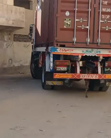 A shipping container on a truck in the street